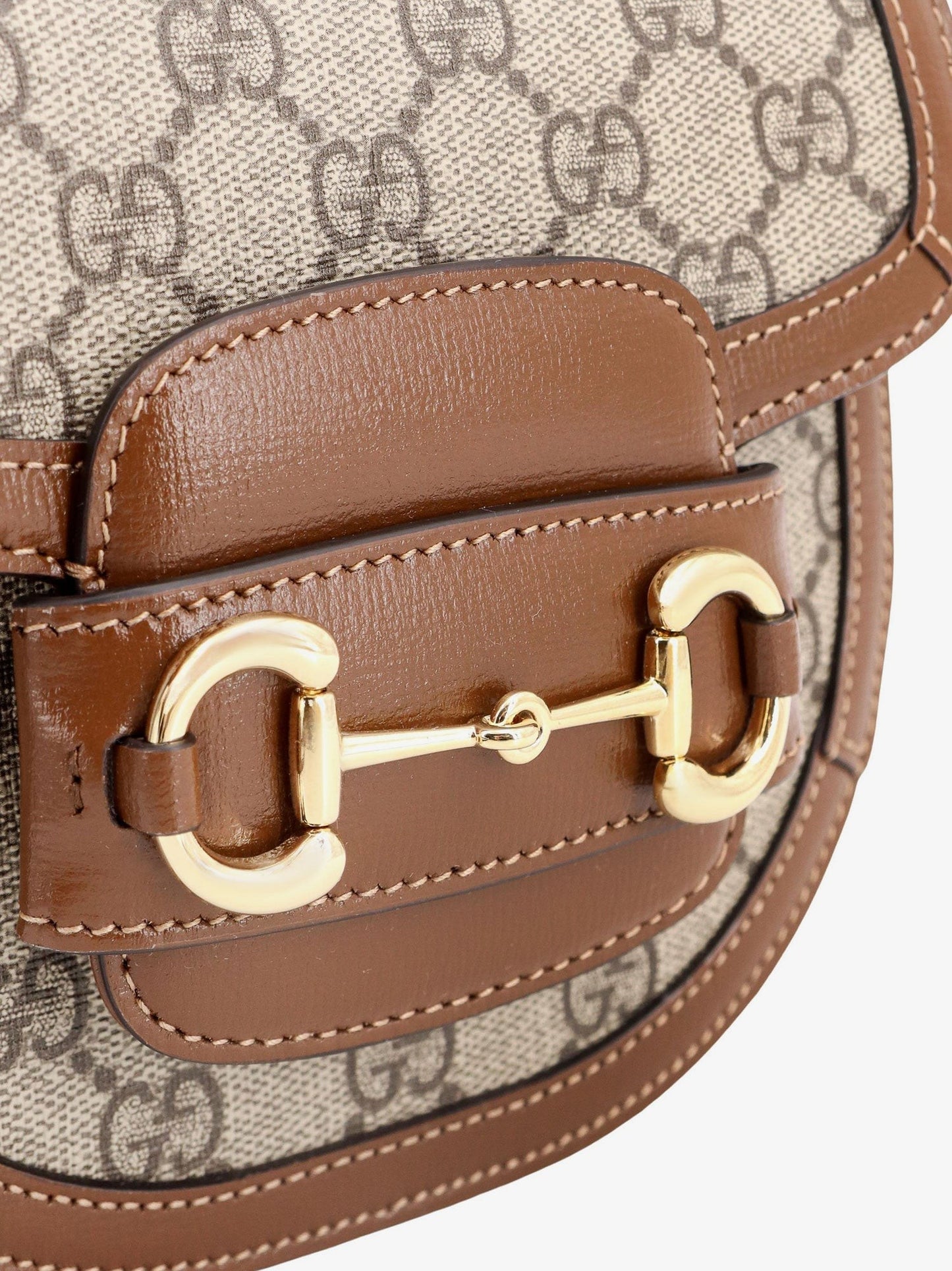 Gucci Gg supreme fabric and leather handbag with iconic horsebit