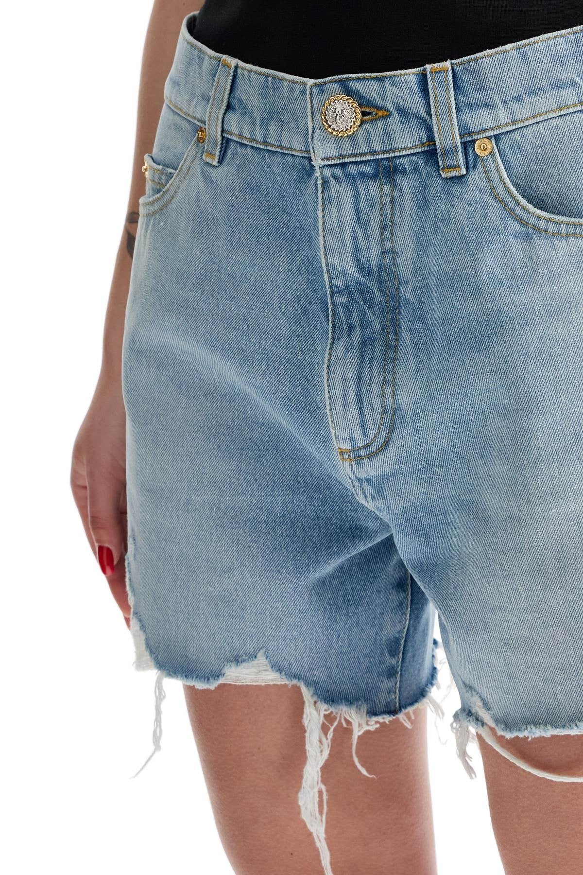 Balmain destroyed denim shorts for a casual