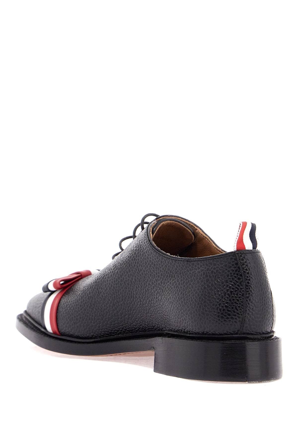 THOM BROWNE elegant wholecut shoes in black calfskin with rwb bow