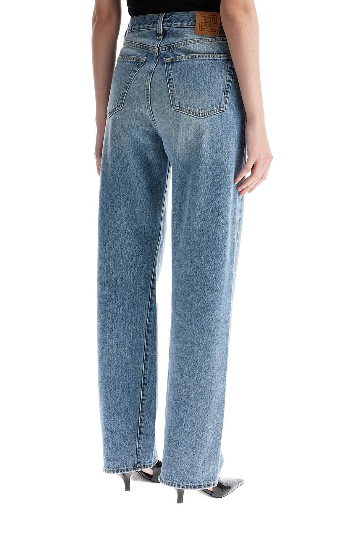 TOTEME wide leg organic cotton jeans in worn blue with twisted seams